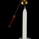 Candle in glass candlestick and candle snuffer