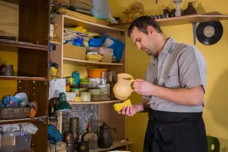 Stages of Clay 101 6 Potter preparing ceramic wares for burning