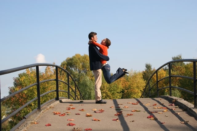 Couple on autumn bridge