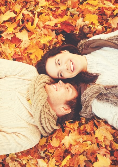 Romantic couple gazing on autumns leaves