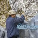 man painting metal heart 1