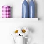 Decorative vases on wooden bathroom shelf