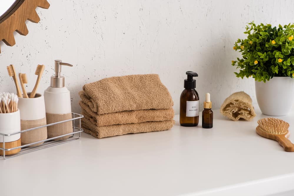 bathroom Shelf with hygiene objects near towels